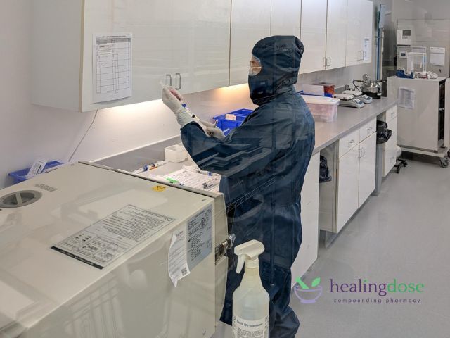 Pharmacist working in sterile compounding cleanroom environment