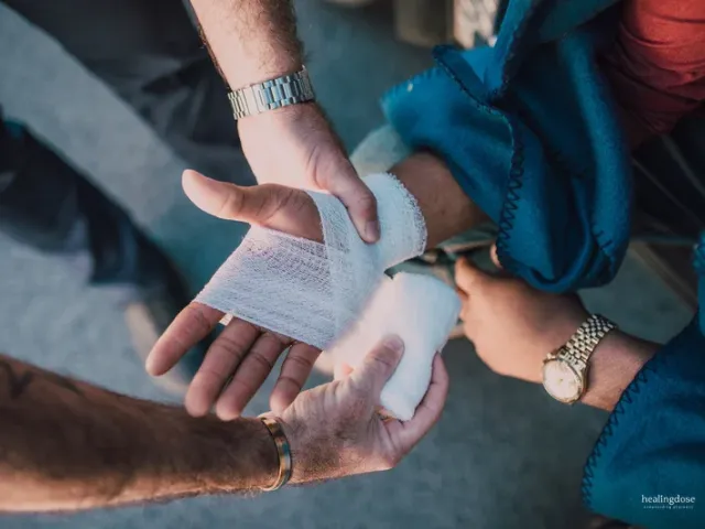 Medic wrapping a wound in bandage