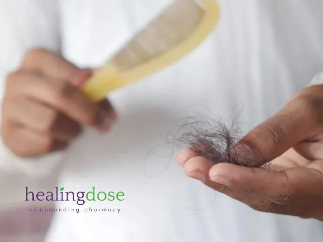 Person Holding Shed Hair and a Hairbrush